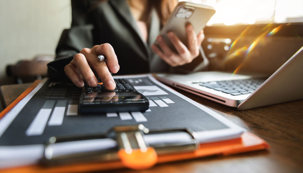 An insurance underwriter crunching numbers and reviewing outcomes.