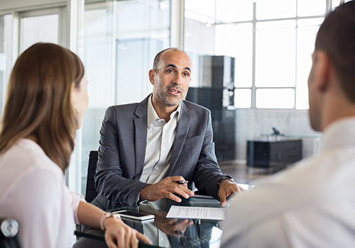 A private equity investor meeting with his clients about investment opportunities.